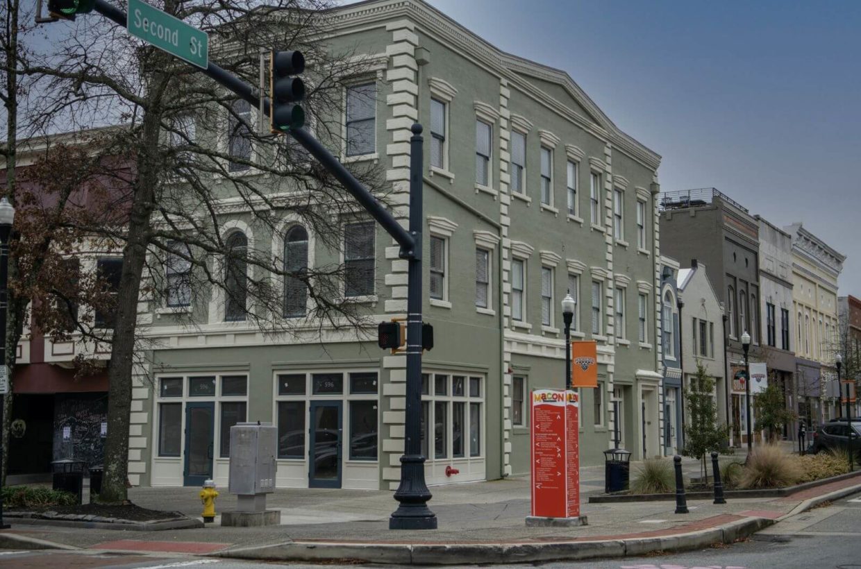 Outside view of a building with lofts on the corner of a street.