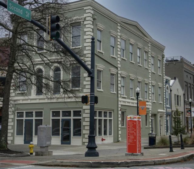 Outside view of a building with lofts on the corner of a street.