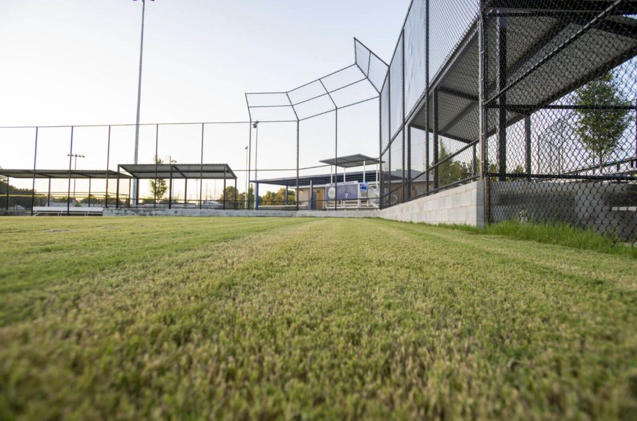 Baseball field with concrete dugouts.