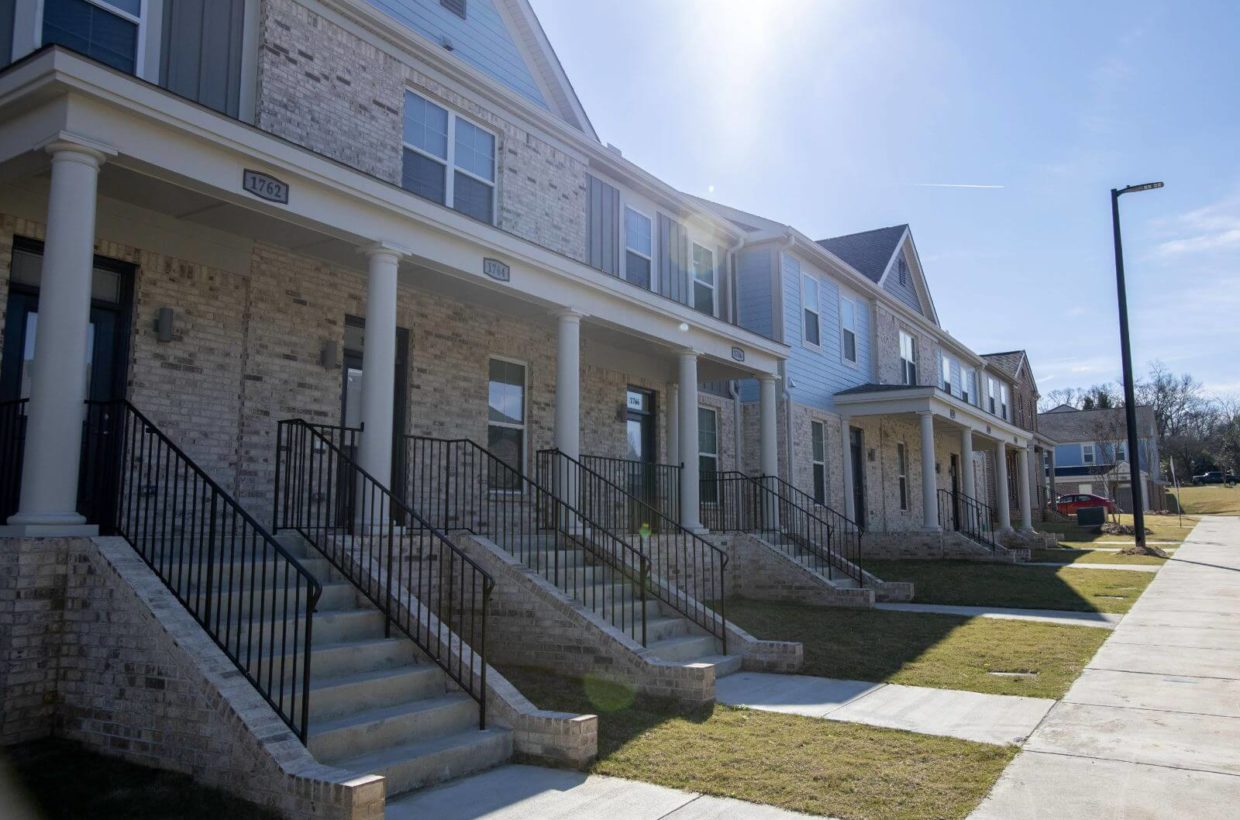 Front view of several duplexes built with wood and brick