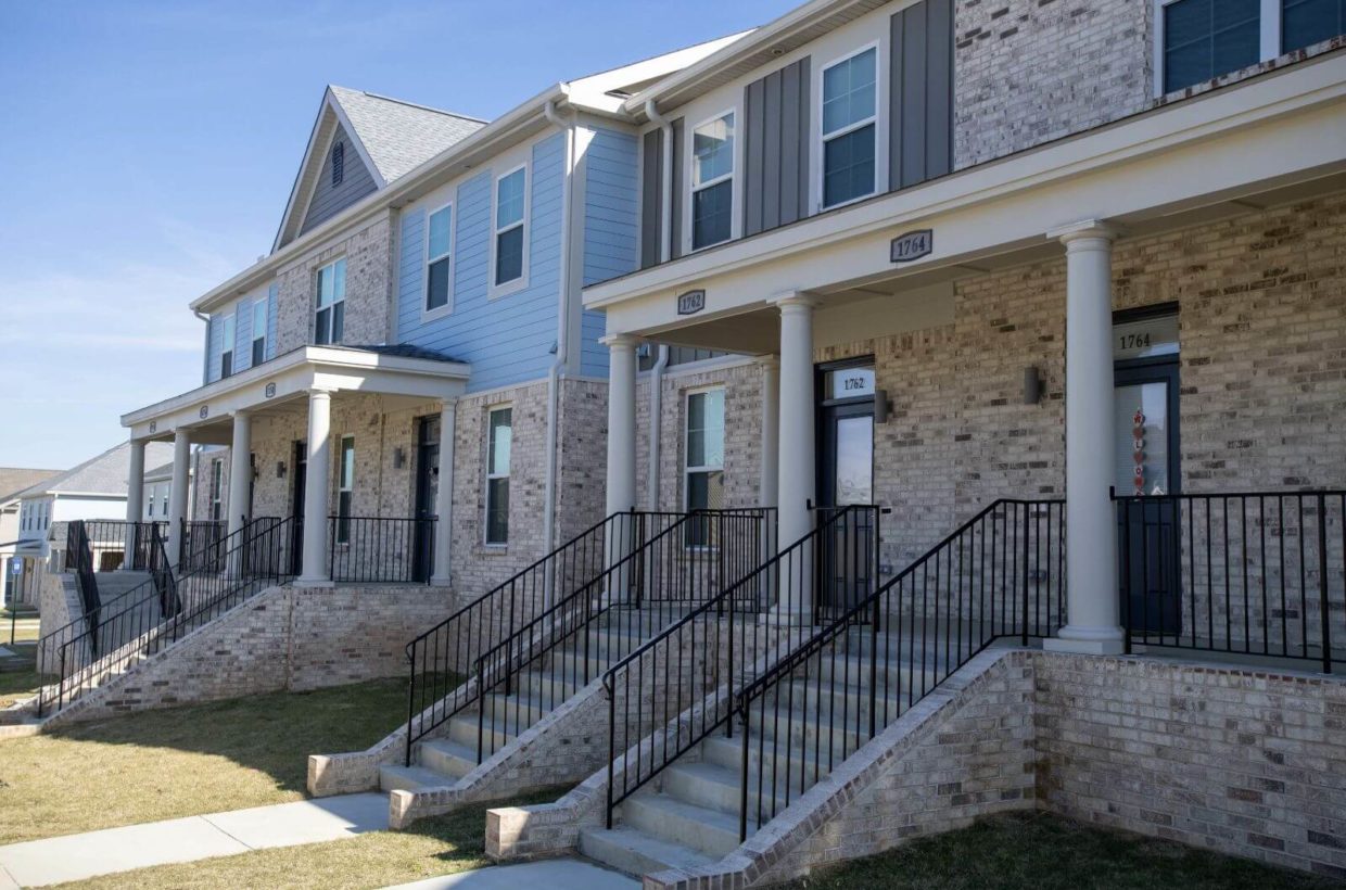 Front view of several duplexes built with wood and brick